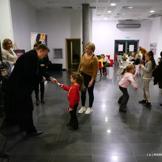 zdjęcie przedstawia widzów oczekujących na wejście na salę teatralną, na foyer w Miejskim Centrum Kultury w Bełchatowie 
